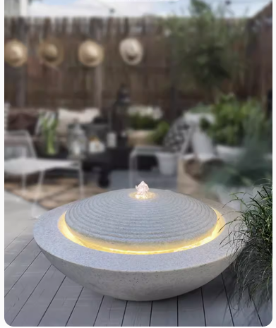 Garden water fountain feature, modern and simple home decoration, brings wealth and prosperity, crafted from decorative stones, resembling a treasure basin.