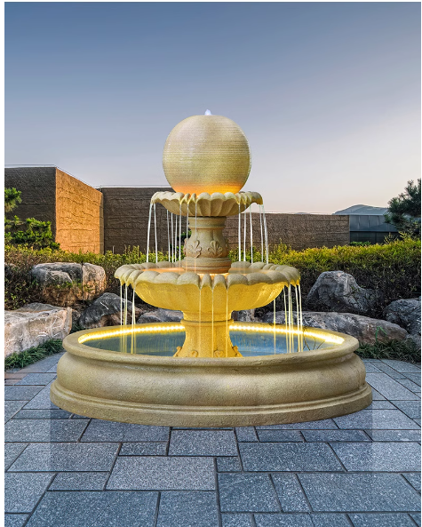 This outdoor courtyard fish pond features a large European-style round water fountain sculpture that doubles as a humidifier and floor decoration.